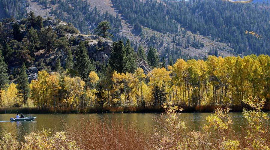 gull lake with a boat, fall colors, and the mountains