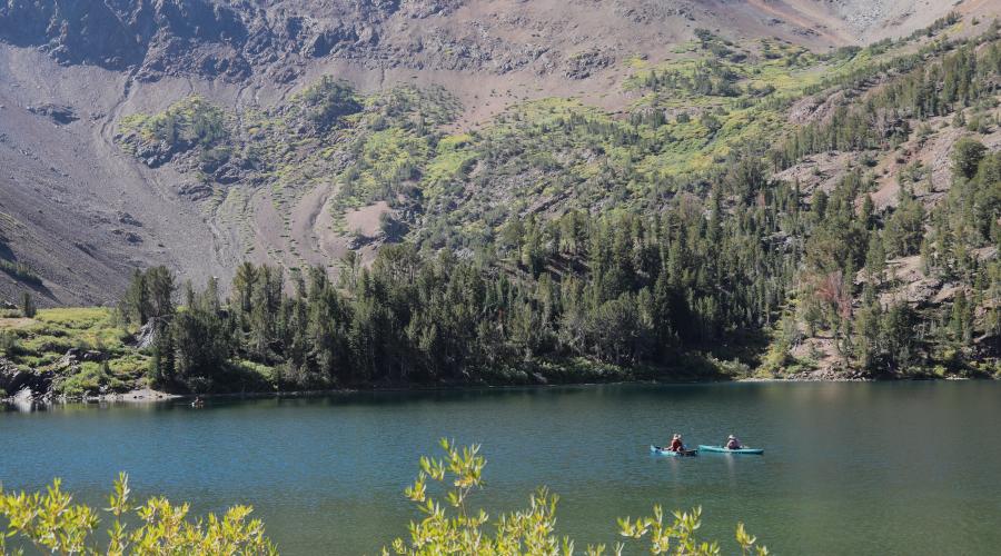 two kayaks on a lake with mountains and fall colors