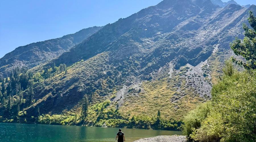 Person walking in the clear water of Convict Lake
