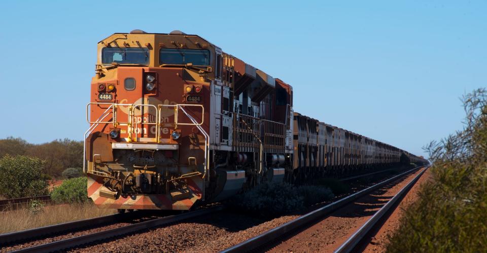 An iron ore train along the rail access road near Tom Price