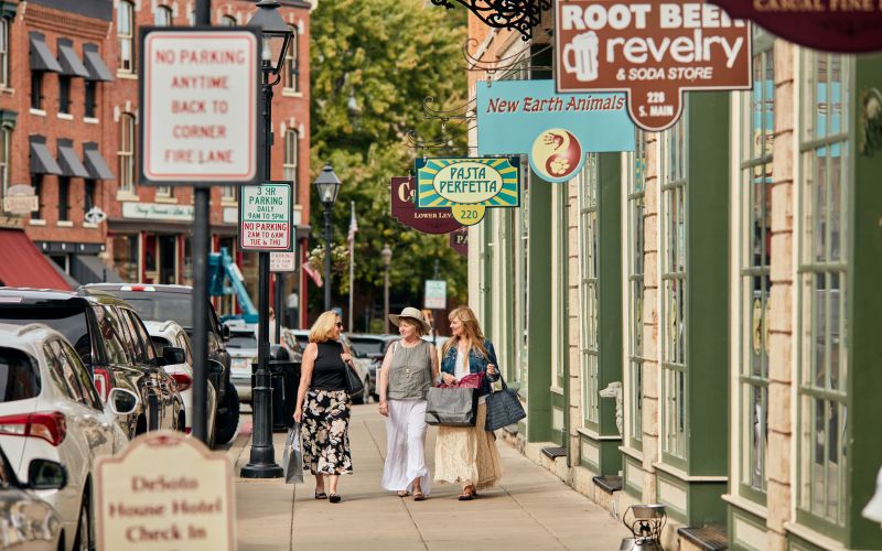 Galena Main Street sidewalk sale with shoppers browsing tables