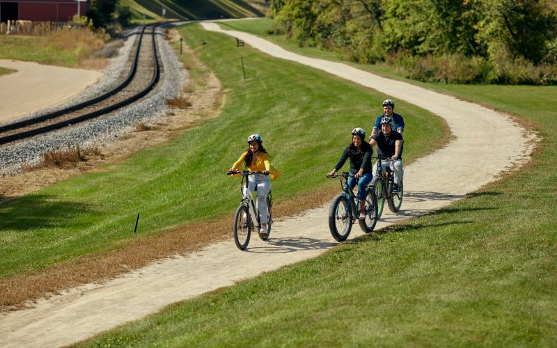 Walkers and cyclists on the Galena River Trail alongside the Galena River
