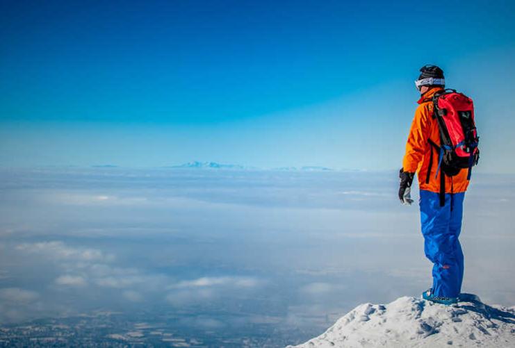 Skier standing on a peak in Utah
