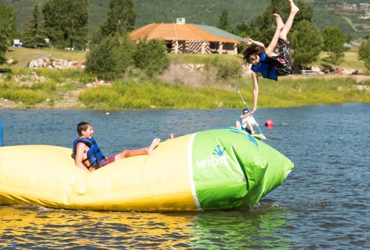 Two Boys on inflatable toy in Jordanelle State Park