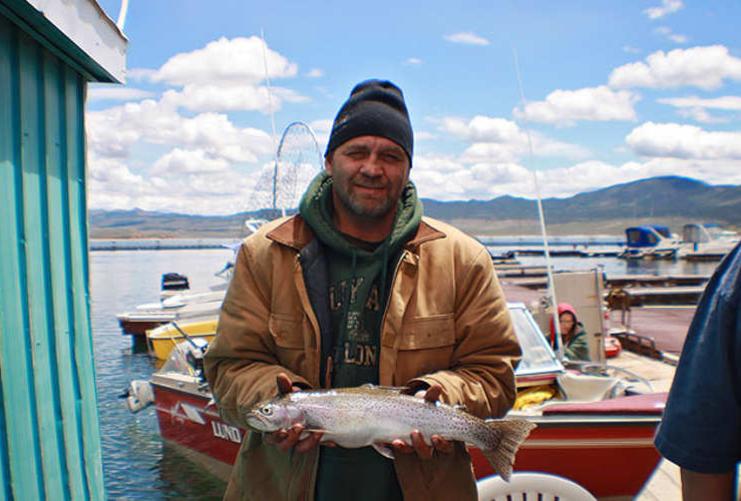 Fisherman holding lake trout fishing contest