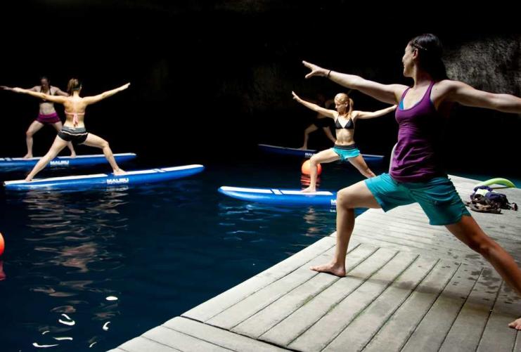 Group doing yoga on paddle boards  at the Homestead Crater