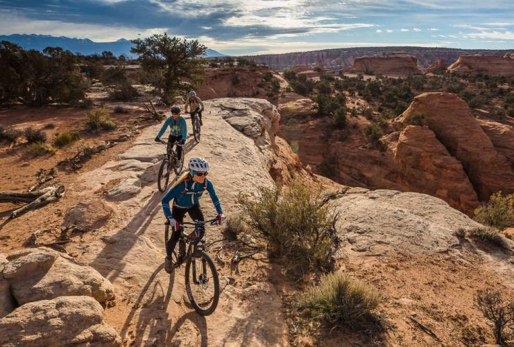 Female bikers on a rocky trail in the Moab area