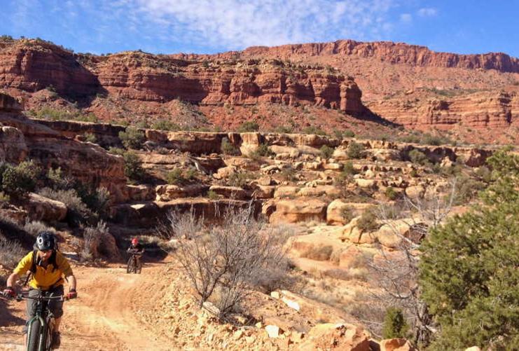 Riders on a flat trail in Southern Utah
