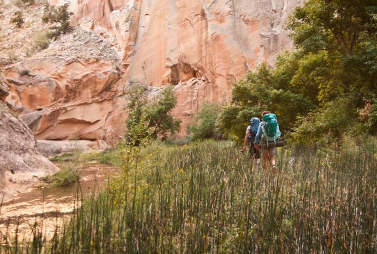 Hikers walking along stream bed in Grand Staircase Escalante