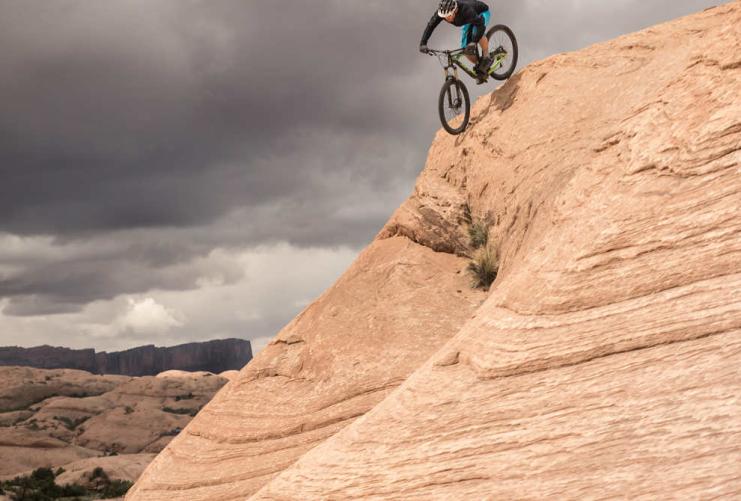 Mountain biker coming down a steep slick rock incline