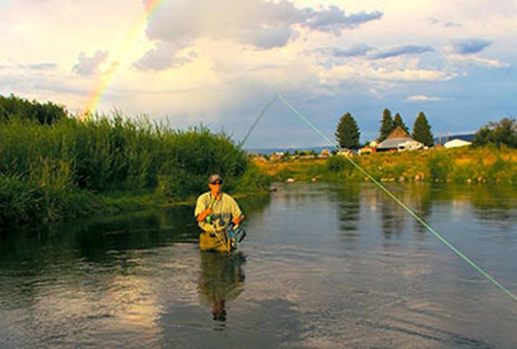 Fisherman with line cast into the river
