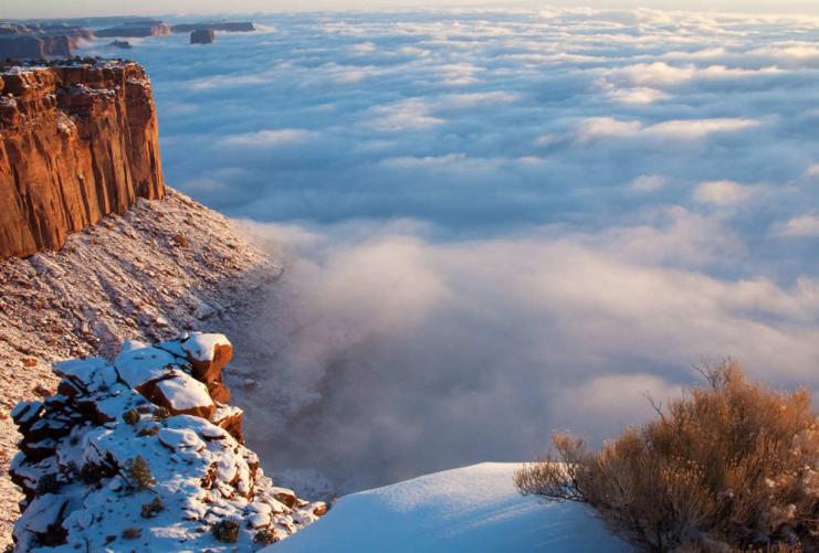 Low level clouds below snowy cliffs near Moab Utah
