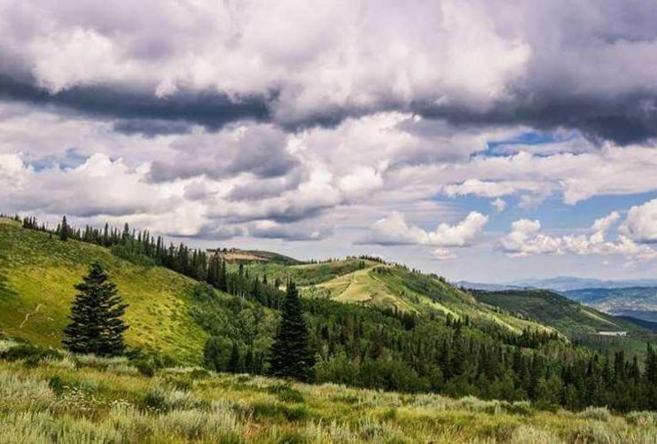 Utah's mountains in the summer with a cloudy sky above