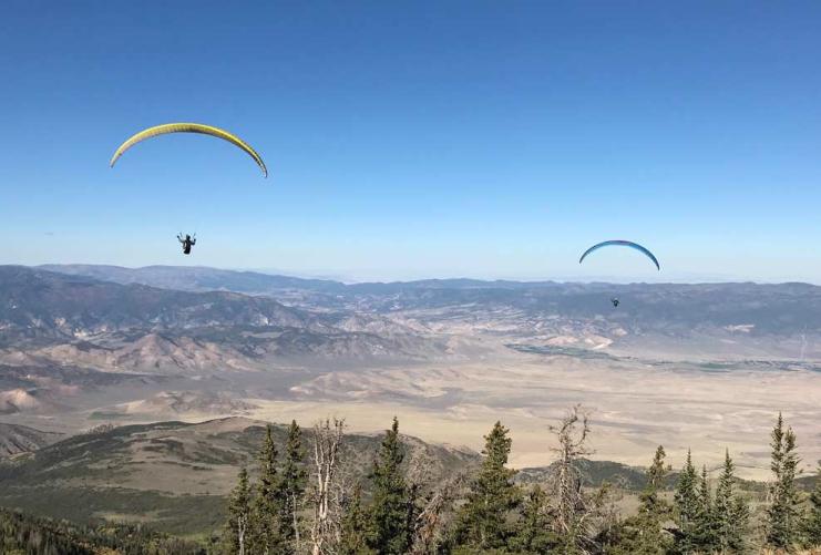 Two paragliders in Utah mountains