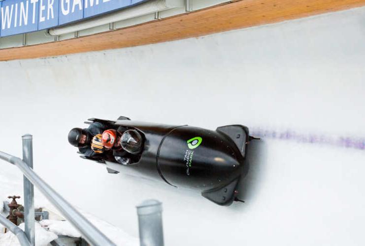 Bobsledders moving down icy track