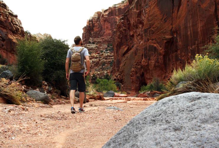 Hiker walking along trail in Green River Utah
