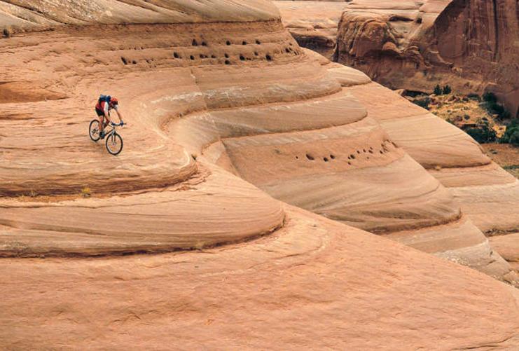 Mountain biker coming down slick rock