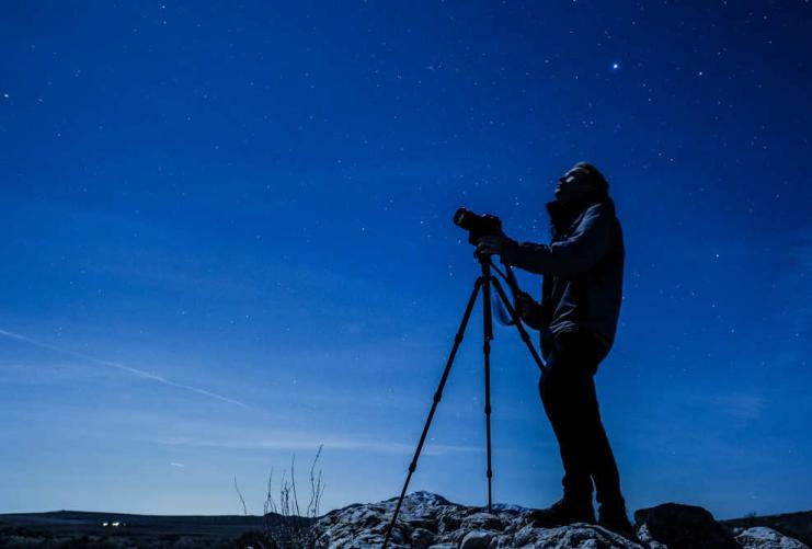 Photographer taking pictures of the night sky in Davis County