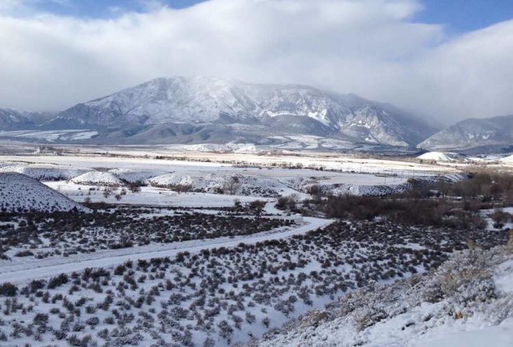 Mountain valley covered in snow and sagebrush.