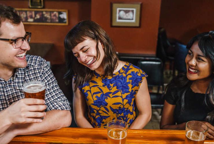 Friends sitting together at a bar