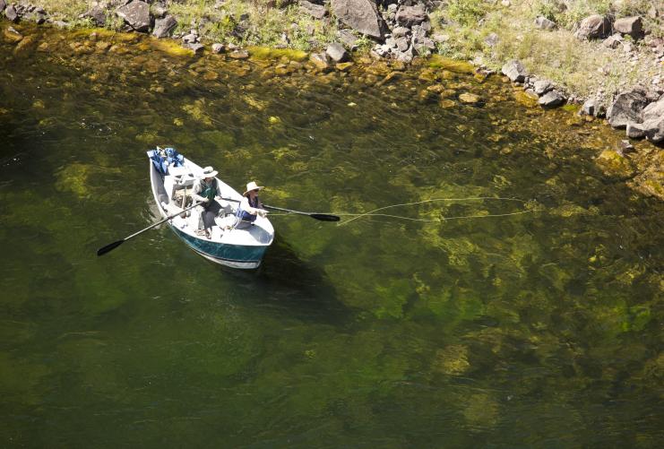 Man fly fishing from a boat