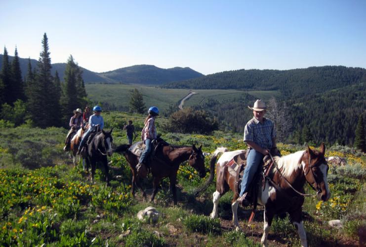 Tour Group horseback riding in Logan Canyon with Beaver Creek Lodge