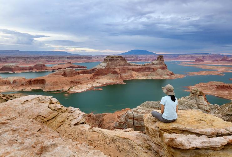 Woman sitting on rocks overlooking Lake Powell