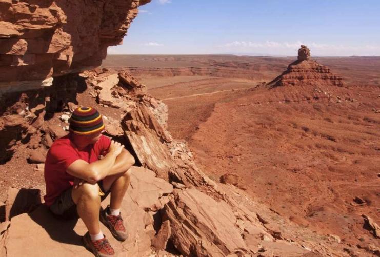Hiker sitting in desert by Blanding