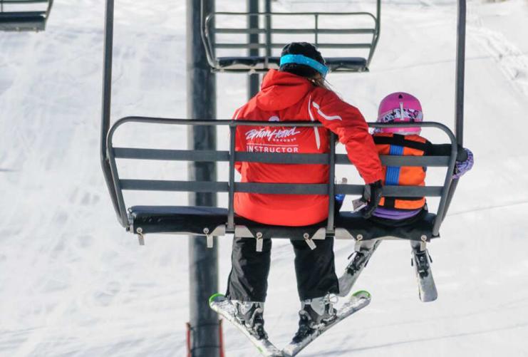 Parent and child on a ski lift at Brian Head