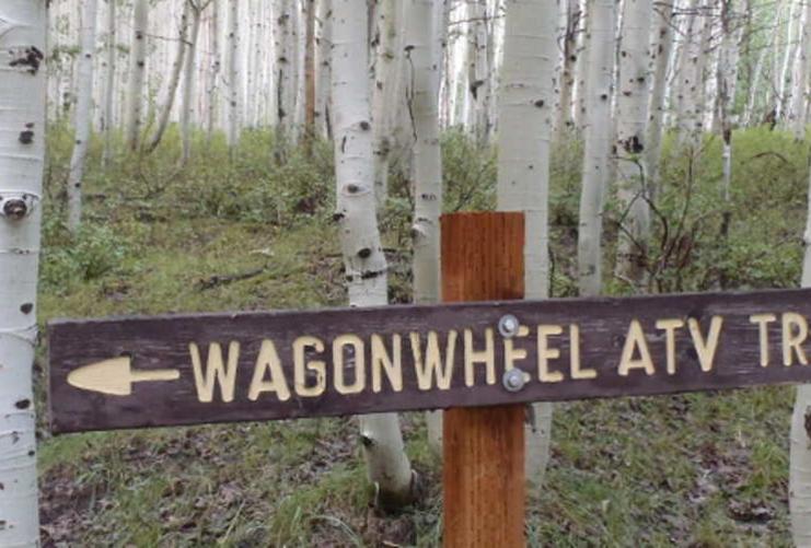 Wagonwheel atv trail sign and aspen trees