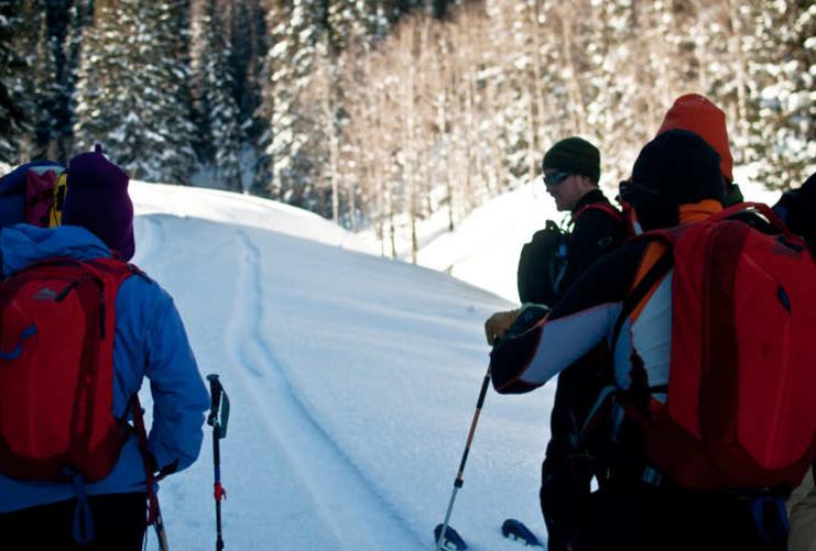 Skiers moving along flat track