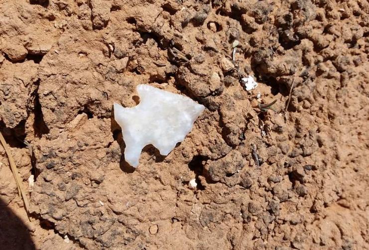 Native American arrow head laying on the dirt