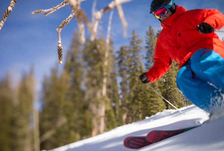 Skier in Red Coat and Blue pants