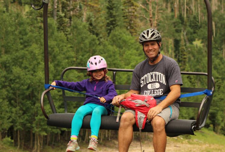 Father and daughter riding the ski lift at Brian Head Ski Resort