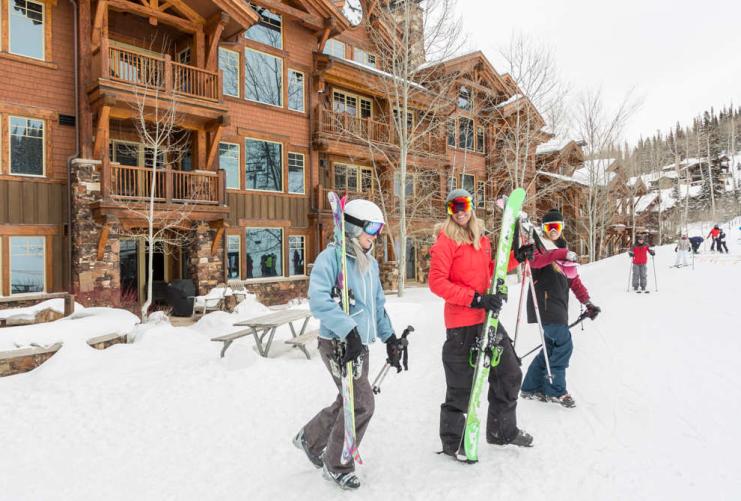 Group of skiers standing in front of hotel at Deer Valley Utah