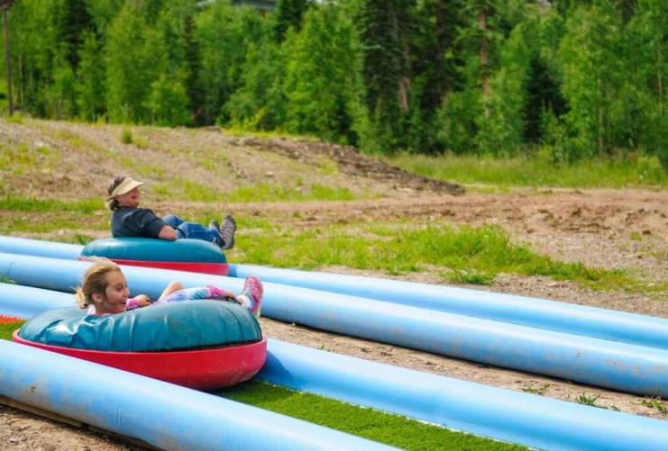 Two people tubing in the summer at Brian Head Ski resort