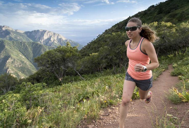 Woman running on Grandeur Peak Trail