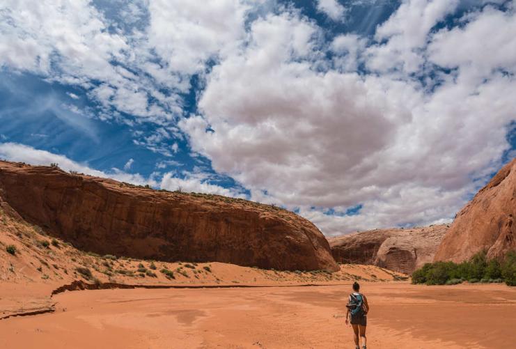 Hiker walking along dry wash in Grand Staircase National Monument