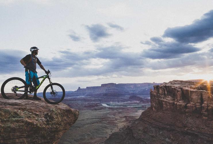 Mountain Biker overlooking red rock canyons of southern Utah