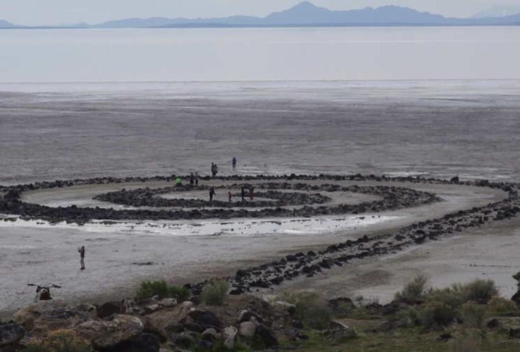 View of people walking out by the Spiral Jetty in the Great Salt Lake