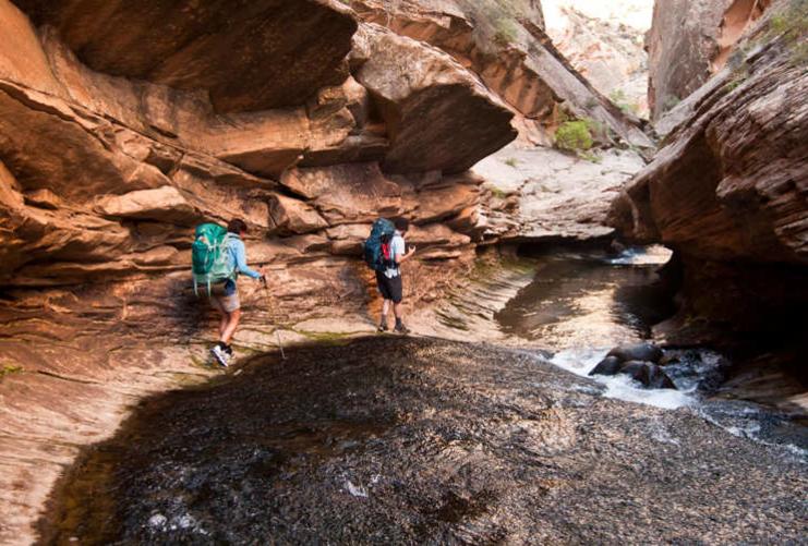 Hikers in slot canyon in Grand Staircase Escalante
