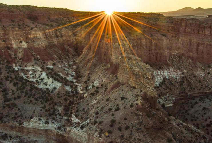Sun going down behind red rock cliffs at Capitol Reef