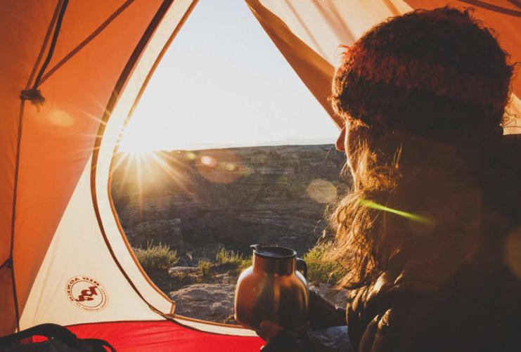 Camper looking out of tent near the San Rafael Swell