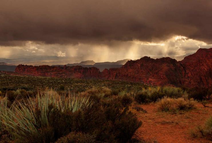 Rain clouds dropping rain over Snow Canyon State Park