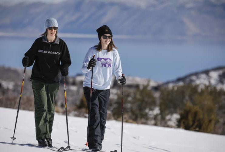 Two people snowmobiling at Bear Lake Utah