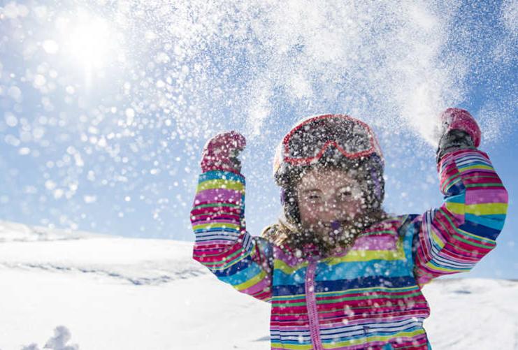 Child throwing snow in the air