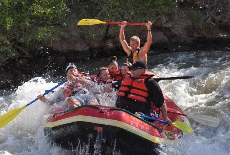 Group of people rafting down river rapids in Southern Utah.