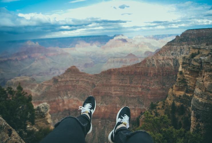 Sitting on the edge of the South Rim trail of the Grand Canyon National Park in Arizona