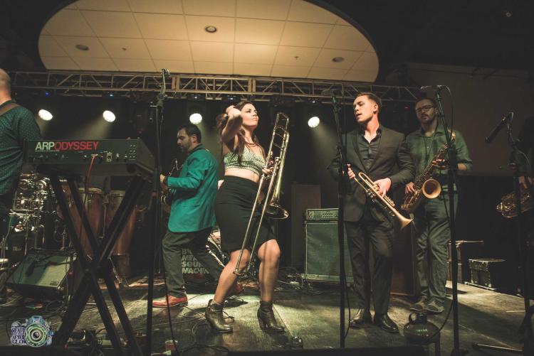 female trombone player on stage with band