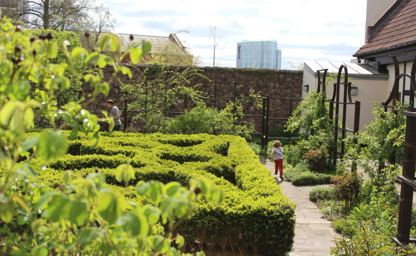 Child playing in the Tudor knot garden at The Red Lodge Museum in Bristol - credit Visit West